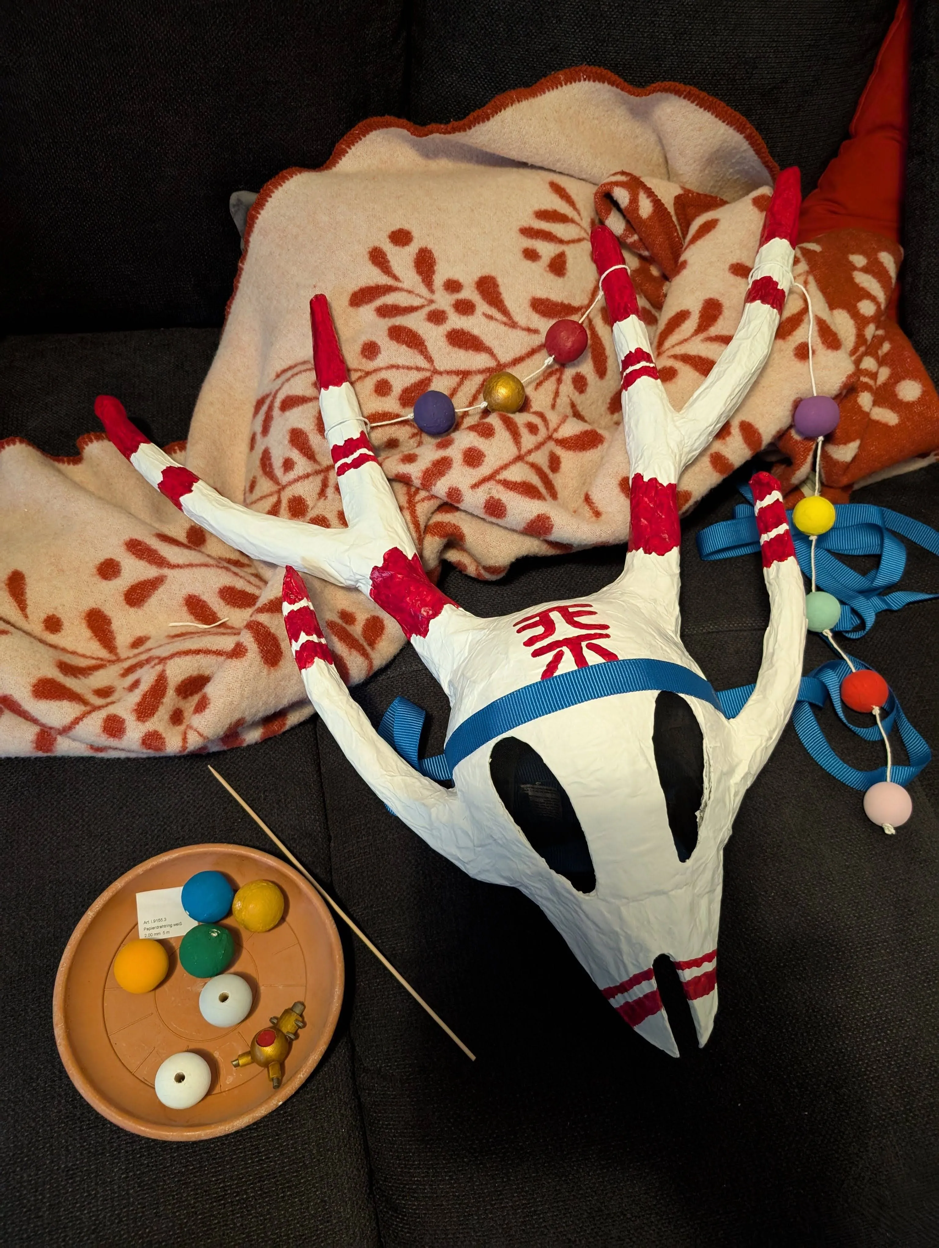 The mask being assembled with the pearls and being compressed by a tension belt to make it fit my head better.