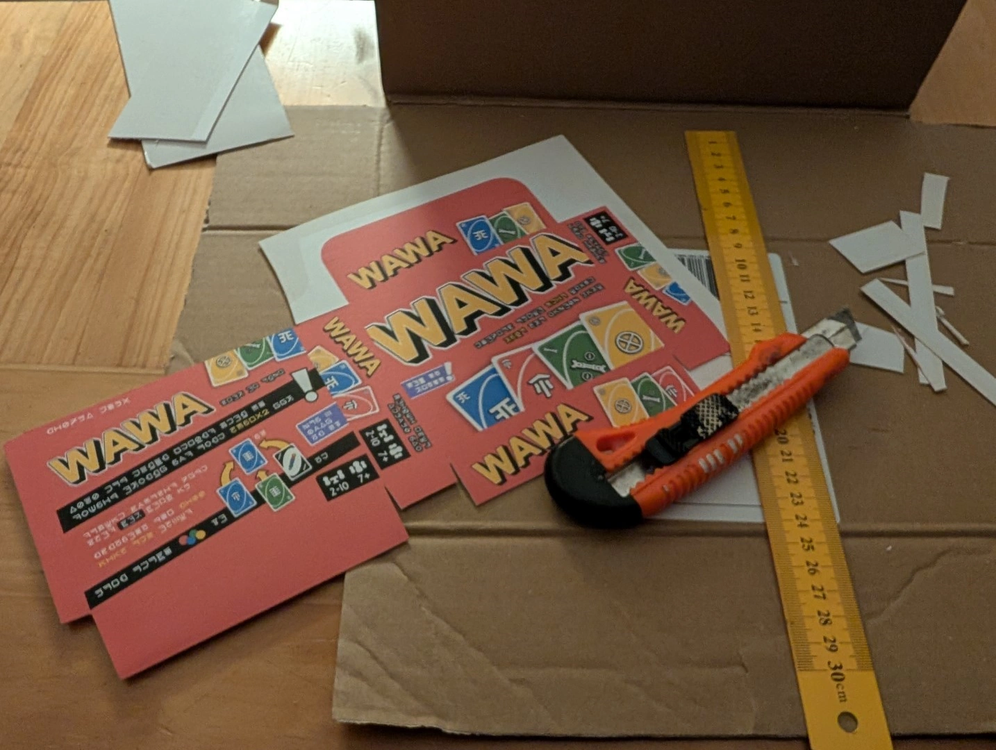 The printed box design on paper and cardboard being cut.